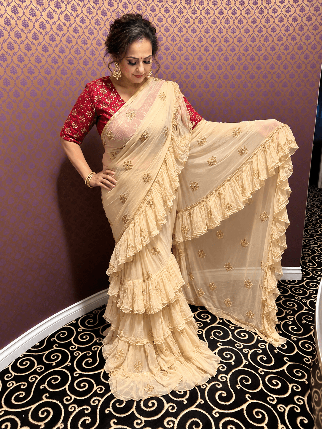 Elegant Ruffled Beige Saree with Gold Embroidery and Red Blouse