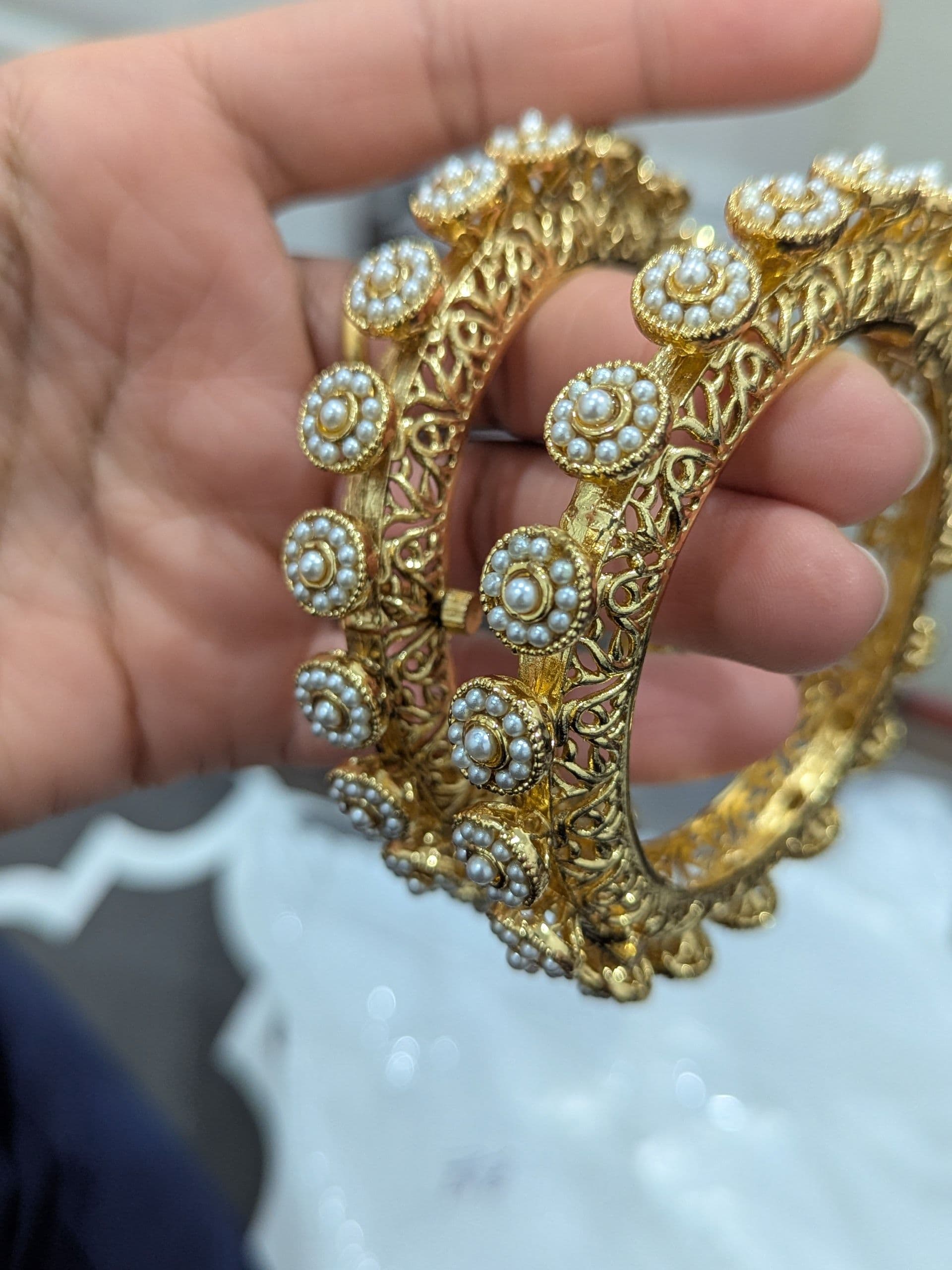 Elegant Gold-Toned Filigree Bangles with Pearl Embellishments - Set of 2